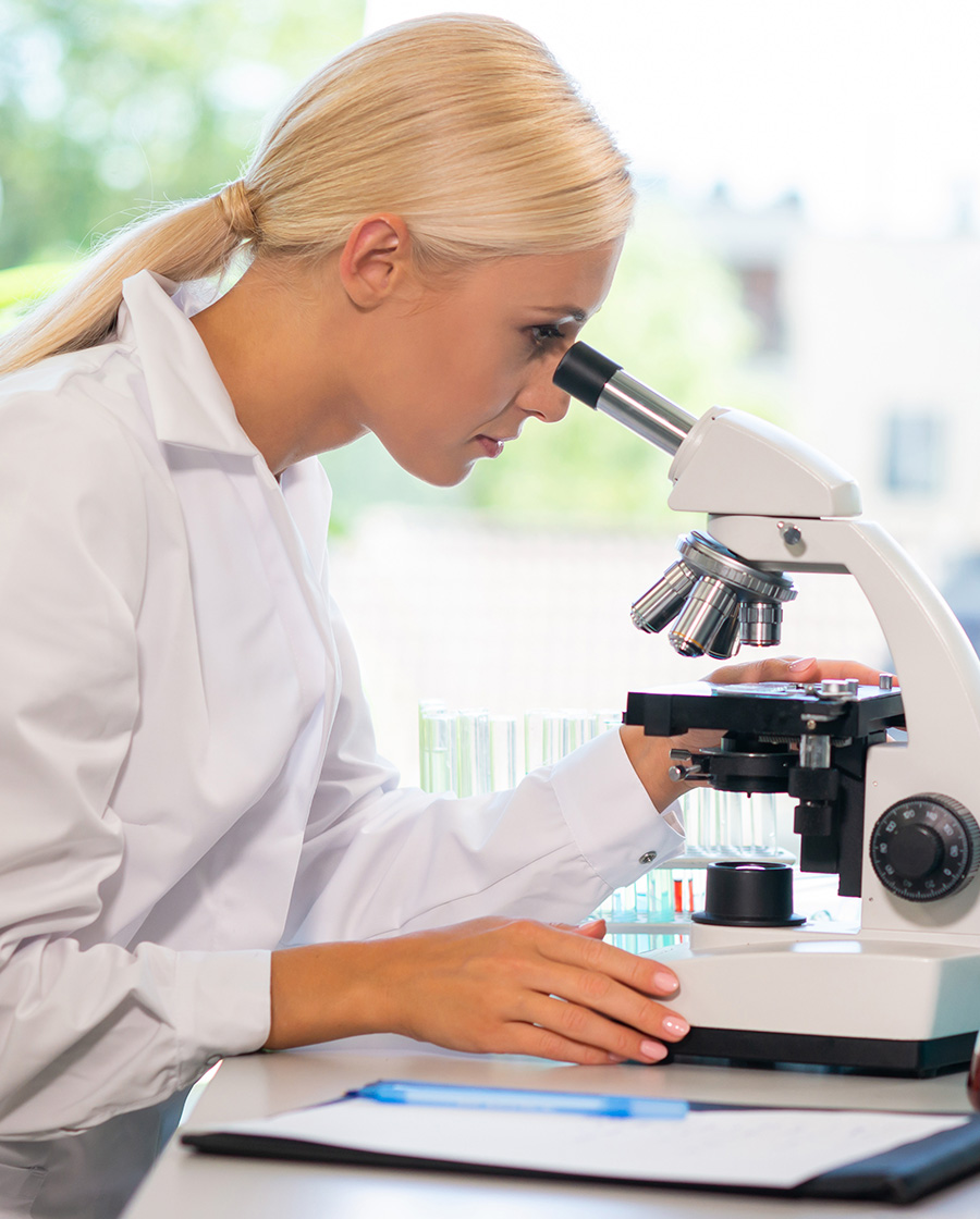 Female doctor using a microscope