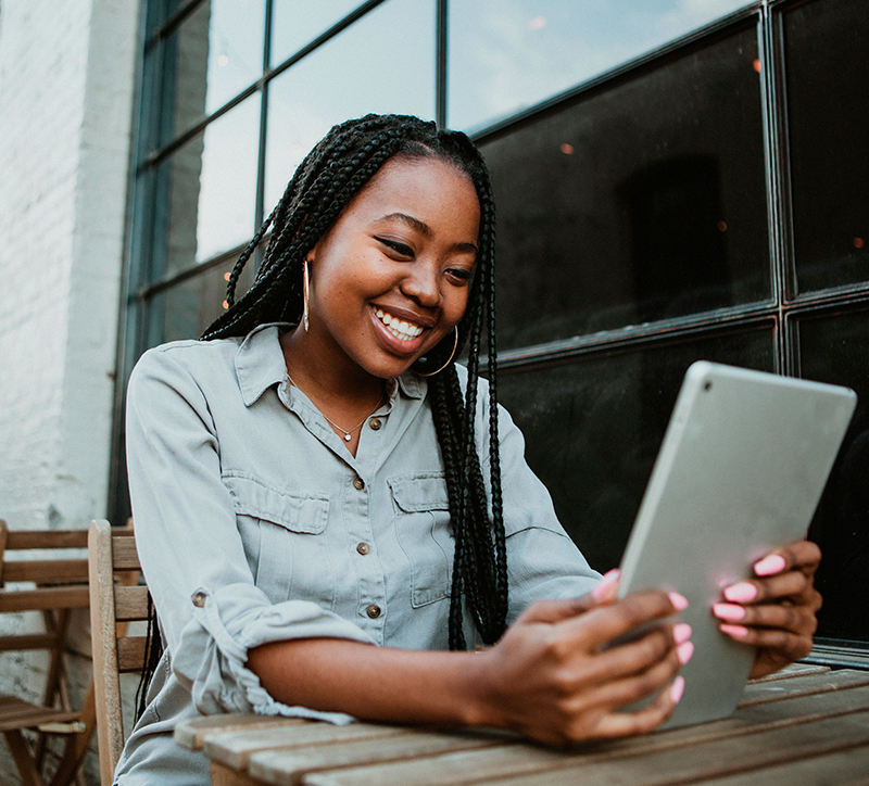 Girl looking a tablet and smiling